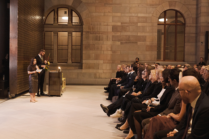 Bild från sidan med kulturminister på scenen till höger och publiken till vänster. 