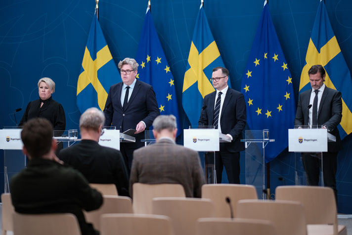 De fyra medverkande står vid var sin talarstol.