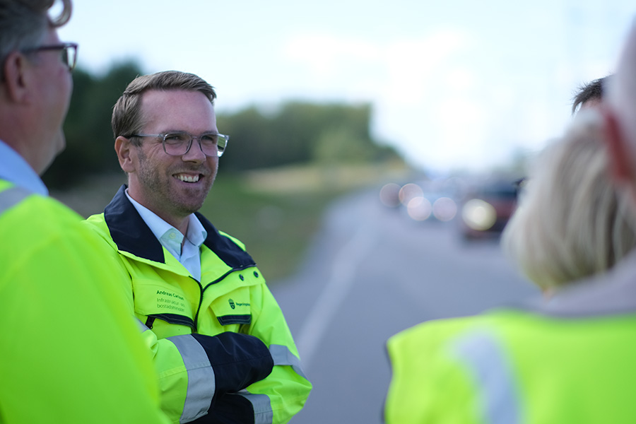 Infrastruktur- och bostadsminister Andreas Carlson pratar med andra besökare vid en trafikkontrollplats.