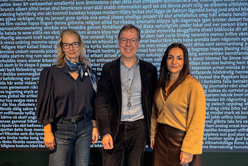 Lotta Edholm, Patrik Hadenius och Parisa Liljestrand står framför en blå vägg full med vit text.