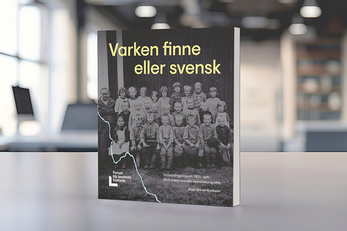 Bild på bok med suddig bakgrund. På omslaget är ett svartvitt skolfoto med text i gulat: "Varken finne eller svensk".